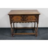 An oak two drawer hall table