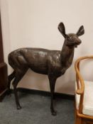 A cast patinated aluminium figure - a doe standing,