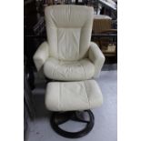 A cream leather swivel chair with matching footstool