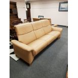 Stressless tan leather reclining three seater and two seater settees.