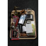 A tray of brass ornaments, letter knife, headphones,