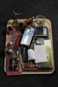 A tray of brass ornaments, letter knife, headphones,
