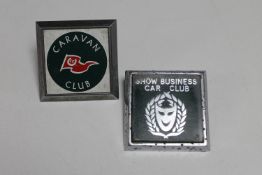 A Caravan club car badge and a Show Business Car Club badge