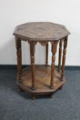 An octagonal carved oak occasional table