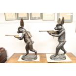 A pair of bronze figures - hares carrying shotguns,