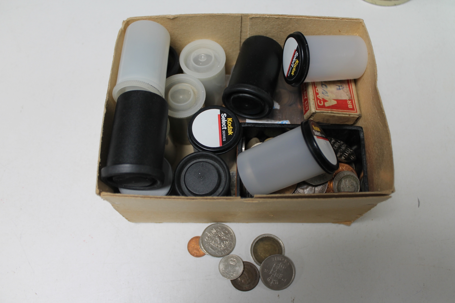 A box containing British pre-decimal and foreign coins