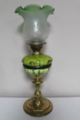 A brass oil lamp with etched shade and painted reservoir CONDITION REPORT: Several