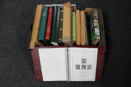 A box of a quantity of stamp albums containing a large collection of assorted stamps,