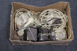 A box of vintage telephones