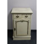 A cream and gilt single door cabinet fitted two drawers