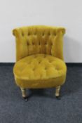 A contemporary buttoned lady's chair in mustard upholstery