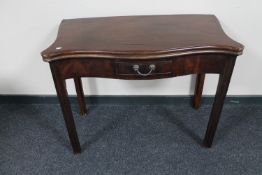 A George III mahogany foldover top tea table