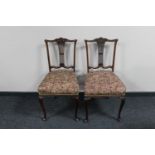 A pair of mahogany dining chairs on cabriole legs