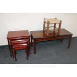 An inlaid mahogany coffee table together with a nest of three tables and a rush seated stool