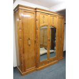 An impressive oriental style parcel gilt breakfront wardrobe