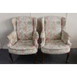 A pair of 20th century wingback armchairs in floral fabric