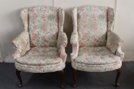 A pair of 20th century wingback armchairs in floral fabric