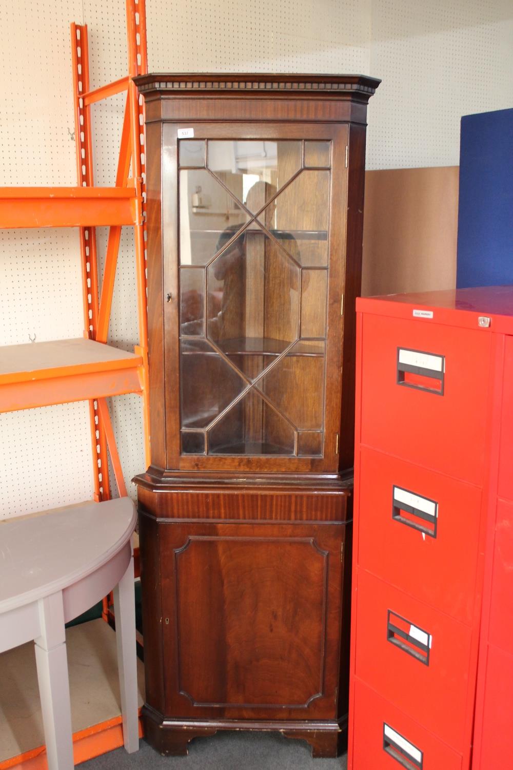 A mahogany corner display cabinet with astragal glazed doors