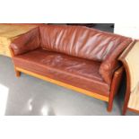 A brown leather three seater settee