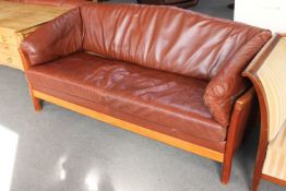 A brown leather three seater settee