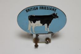A vintage British Friesians car badge