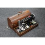 A cased mid 20th century Singer electric sewing machine