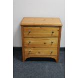 A pine three drawer chest