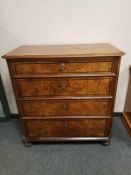A 19th century continental walnut four drawer chest on bun feet,