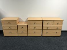 A contemporary five piece pine effect bedroom suite - triple door wardrobe, four drawer chest,