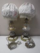 A pair of Victorian glass and metal table lamps with shades and hand painted decoration