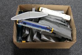 A box containing die cast rolling stock parts and components,