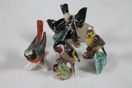 A Beswick bird figure and three Goebel bird figures