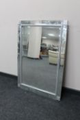 A contemporary all glass framed mirror