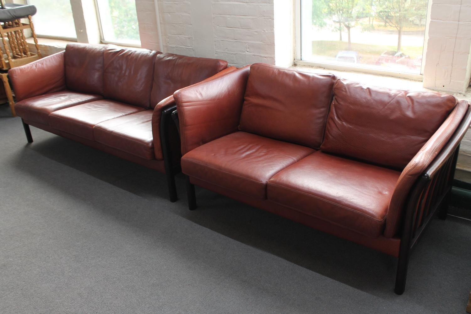 Two Danish stained beech framed settees upholstered in brown leather CONDITION REPORT:
