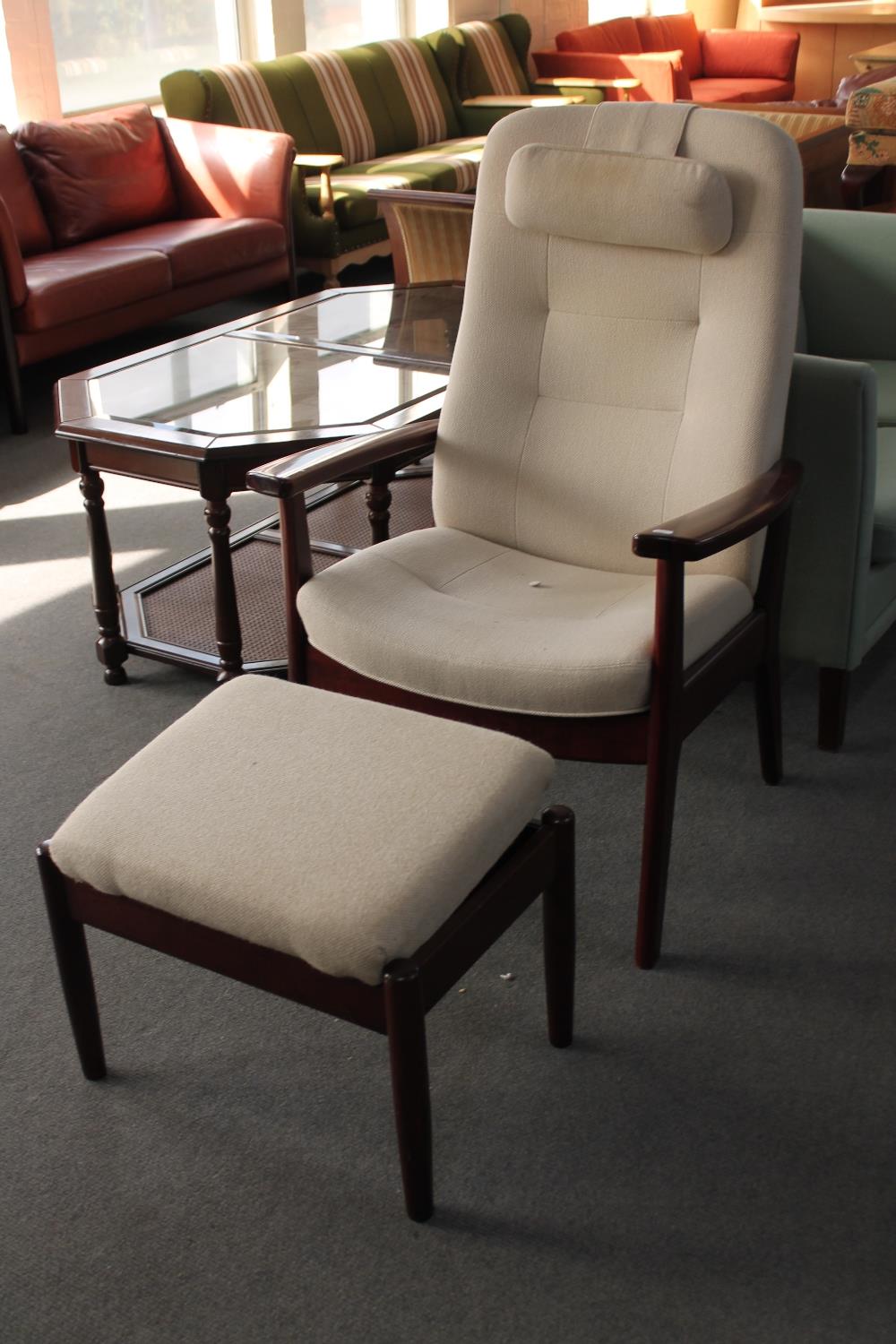 A stained beech adjustable armchair and footstool in beige fabric