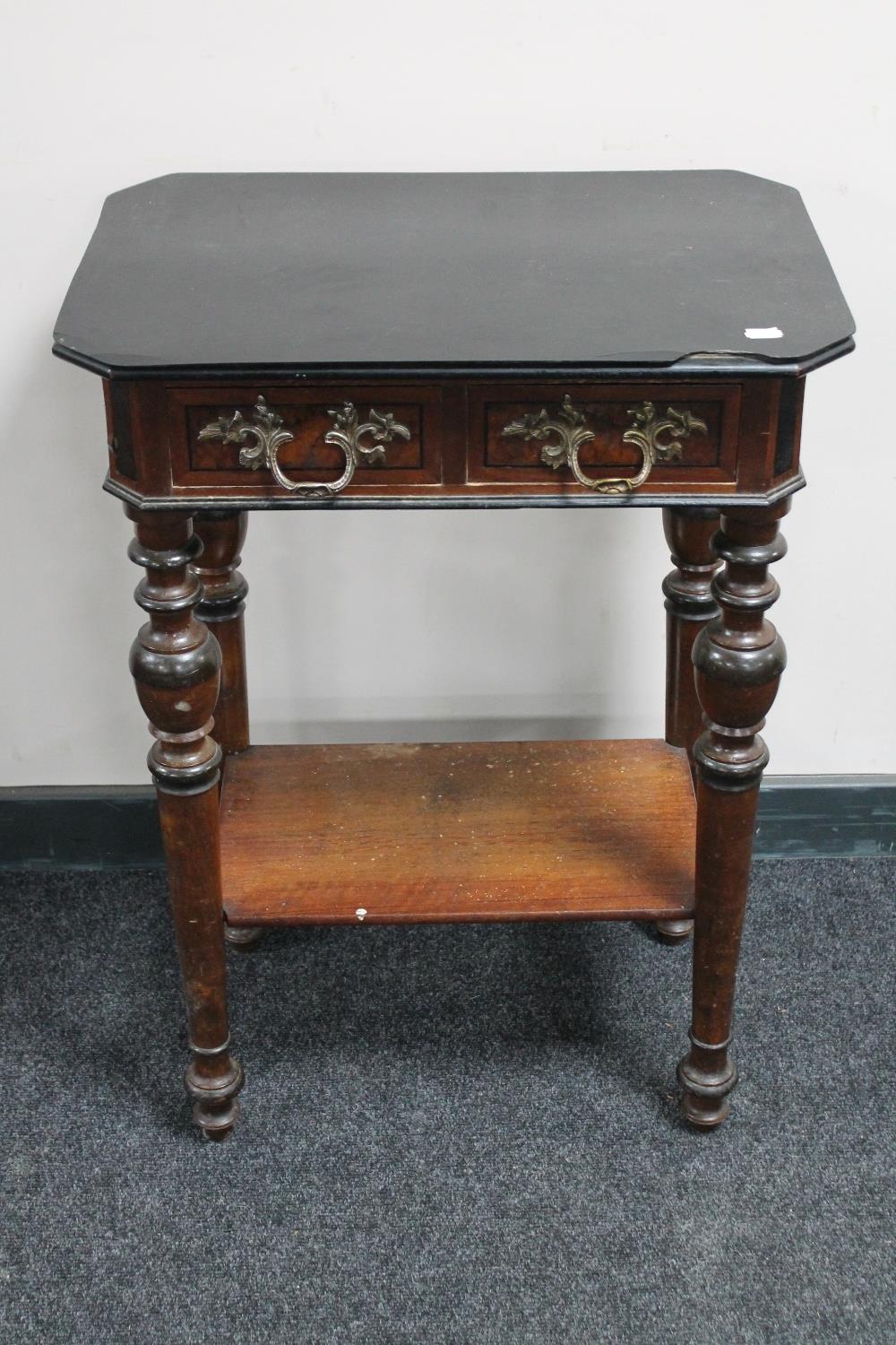 An antique continental mahogany two drawer side table with ornate handles