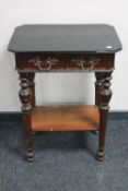 An antique continental mahogany two drawer side table with ornate handles