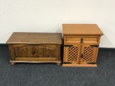 A pine blanket box on bun feet and a pine double door cabinet