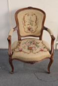 A carved beech framed salon armchair in tapestry fabric