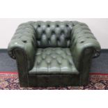 A green buttoned leather Chesterfield style club armchair