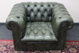 A green buttoned leather Chesterfield style club armchair