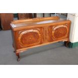 An early 20th century oak sideboard on cabriole legs