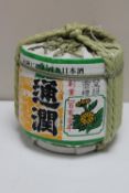 A Japanese sake decanter wrapped in string and paper (sealed)