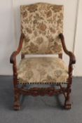 An early 20th century carved continental oak armchair in floral brocade