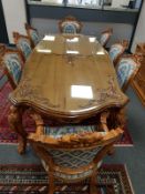 An oriental style carved, high gloss dining table with plate glass top, length 257cm,