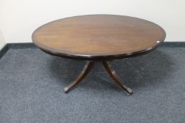 An inlaid mahogany oval coffee table