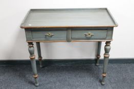 An antique pine painted two drawer side table