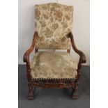 An early 20th century carved continental oak armchair in floral brocade