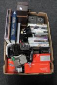 A box containing Polaroid camera, Xbox 360 games,