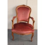 A carved beech framed salon armchair in pink dralon